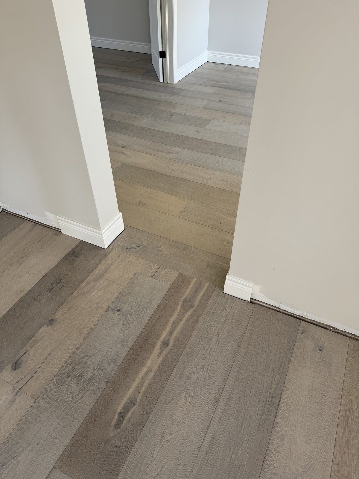 Baseboard and hardwood at doorway