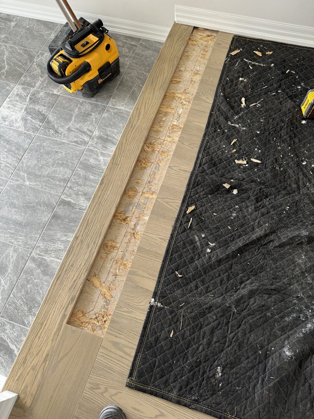 Before: damaged hardwood strip cut out down to the subfloor